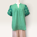 Green embroidered puff-sleeve blouse with textured fabric