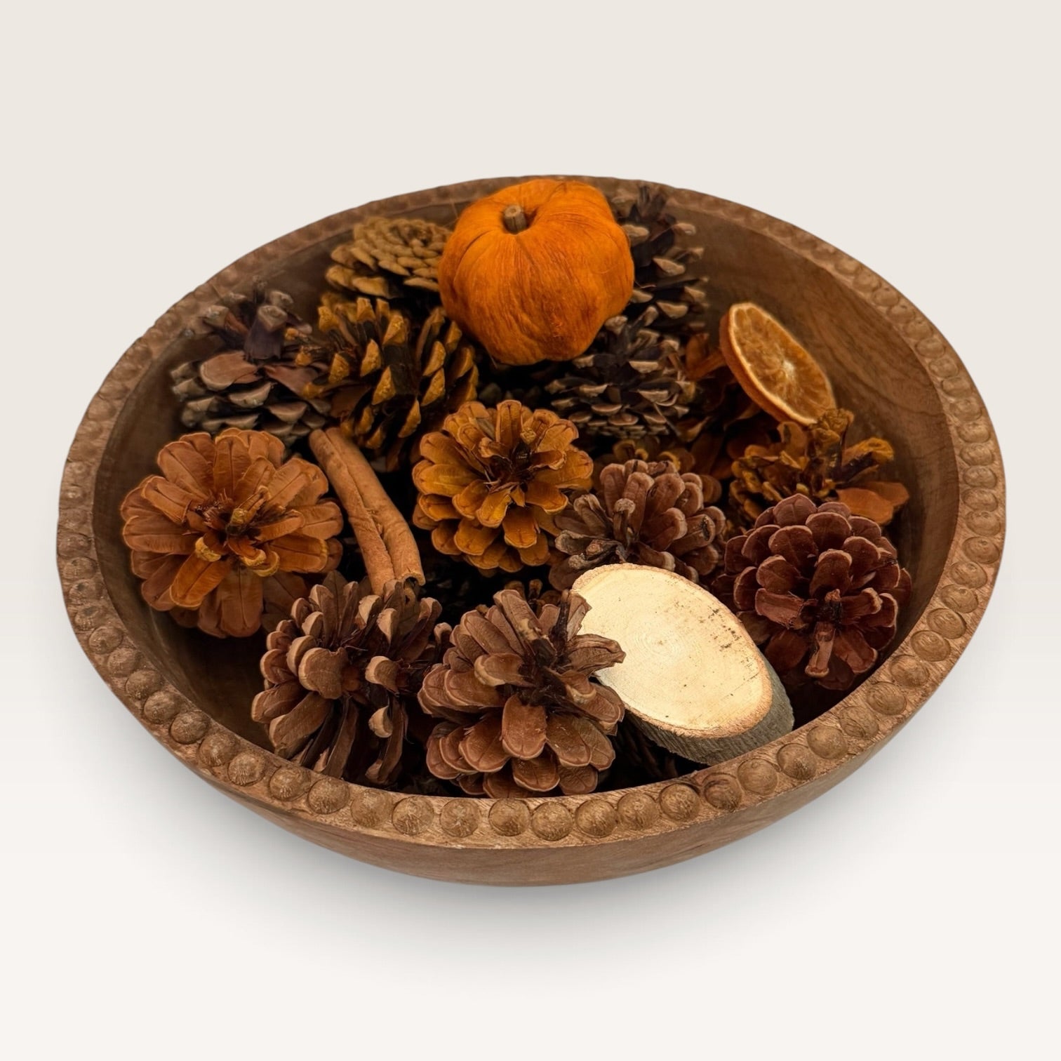 Top view of rustic fall centerpiece with pinecones, pumpkins and seasonal accents