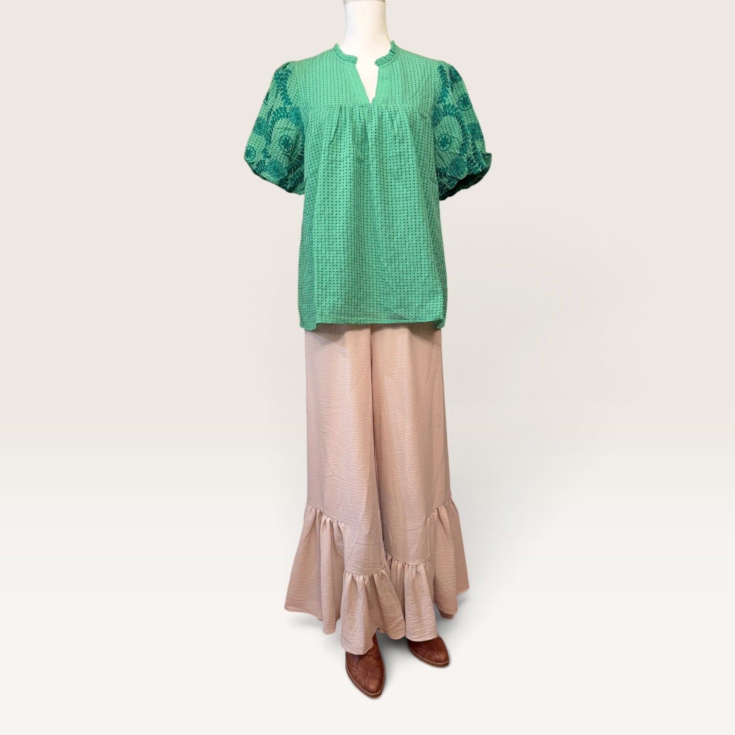 Green embroidered blouse styled with neutral wide-leg pants