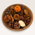 Fall centerpiece in a beaded mango wood bowl with pinecones, pumpkins and rustic accents