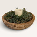 Round carved wood bowl centerpiece with faux ruscus greenery and LED candle