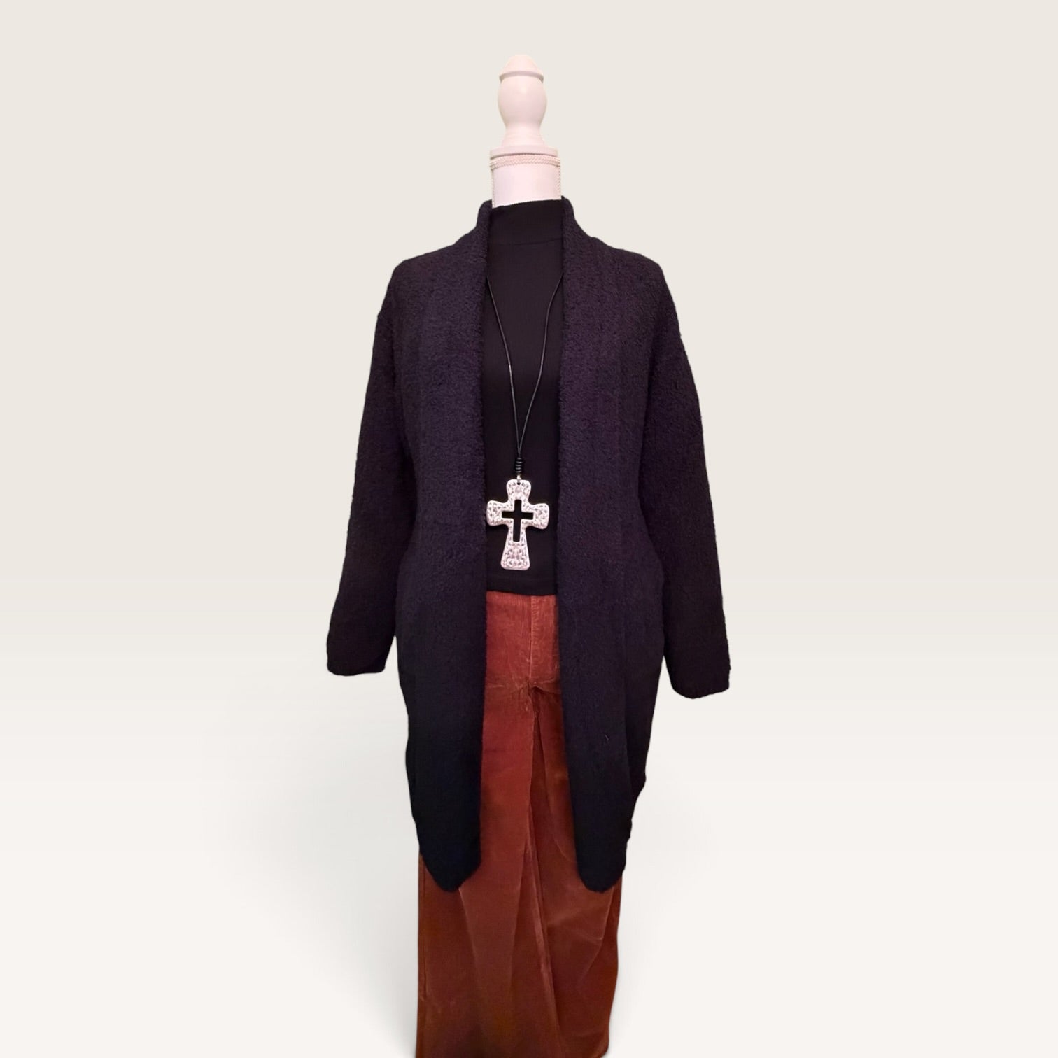 Front view of black open-front knitted cardigan