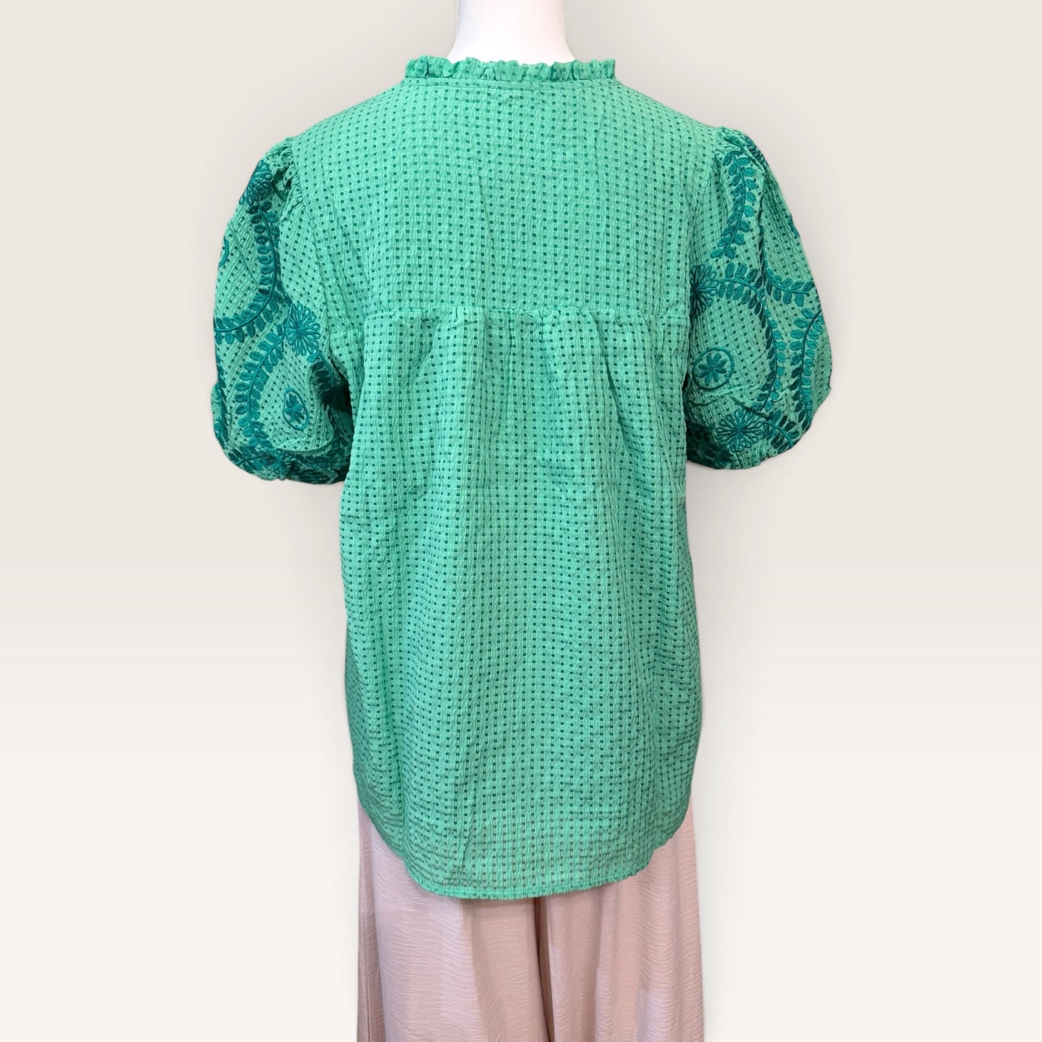 Front view of green embroidered short-sleeve blouse