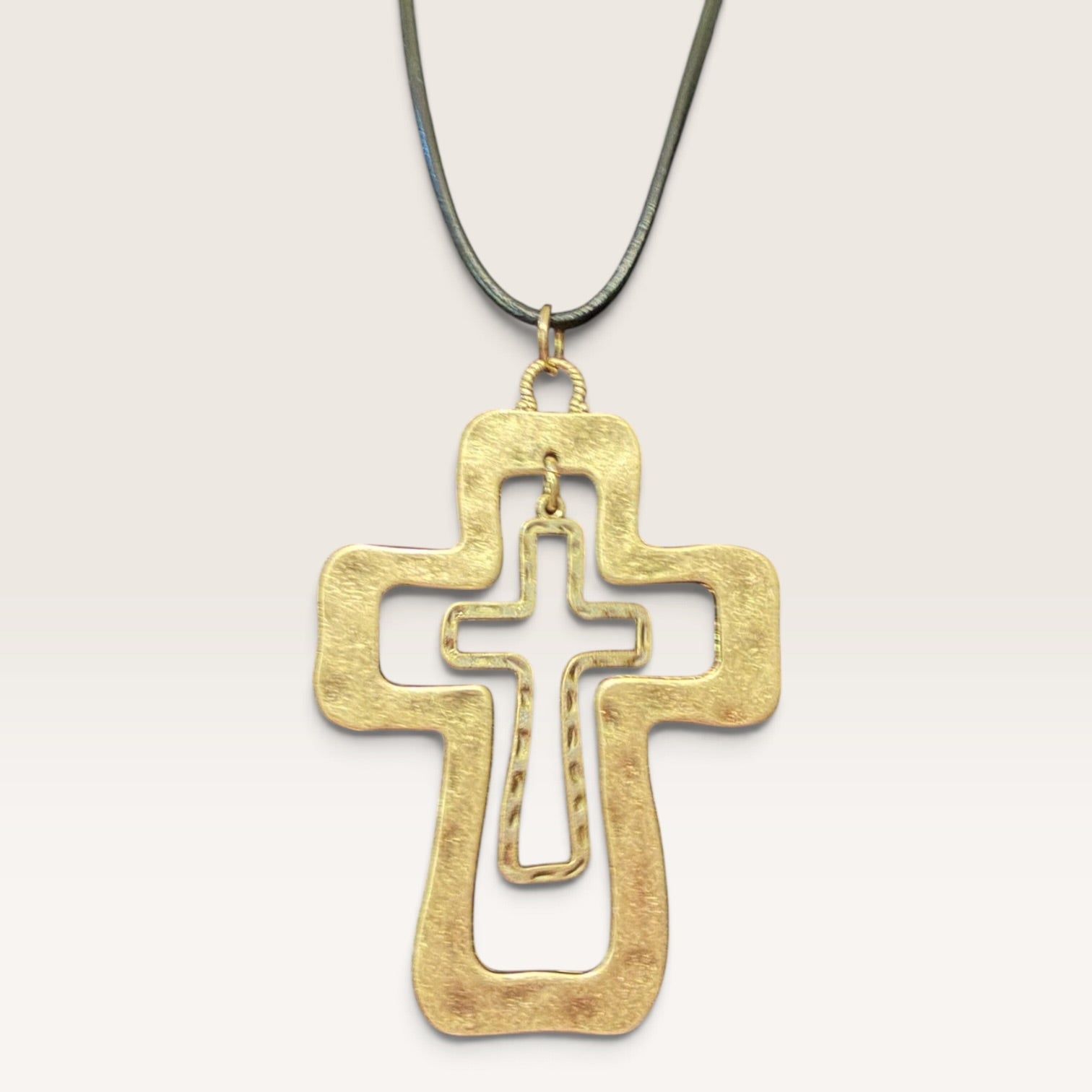 Close-up of layered cross pendant necklace