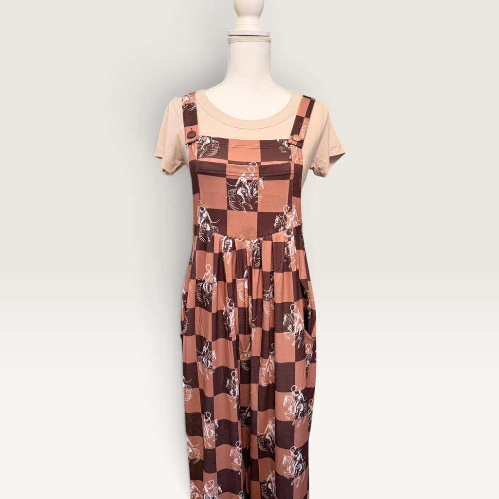 Western checkerboard overalls layered over cream top