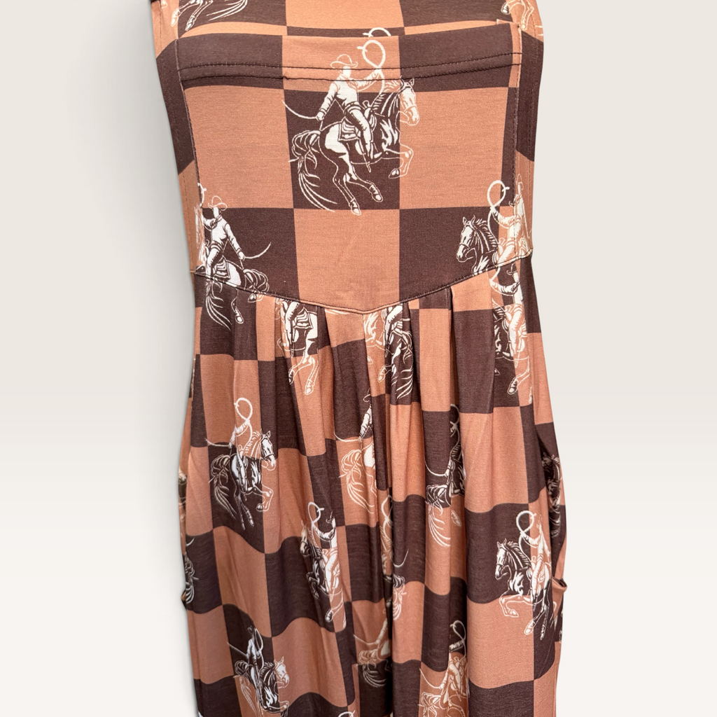 Close-up of horse and rider print on checkerboard overalls