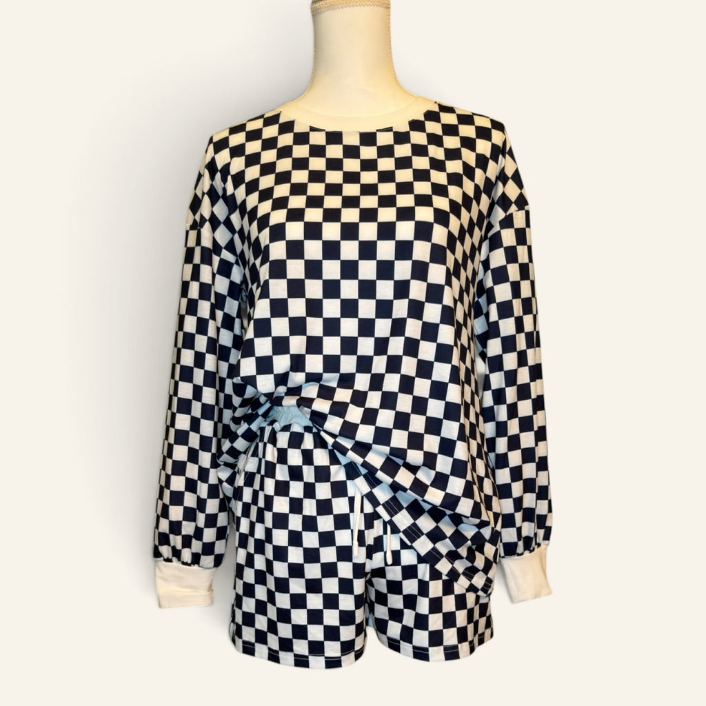 Front view of navy and white checkered long-sleeve top and shorts set