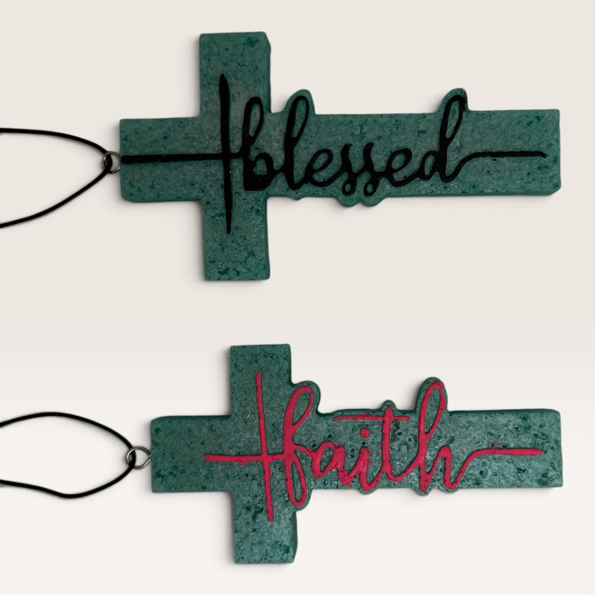 Sadie's handmade Blessed and Faith cross car freshies in turquoise with black and pink lettering.