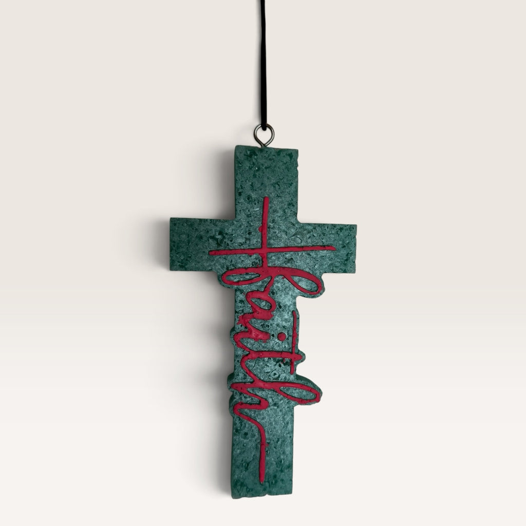 Sadie's handmade Faith cross car freshie in turquoise with pink lettering.