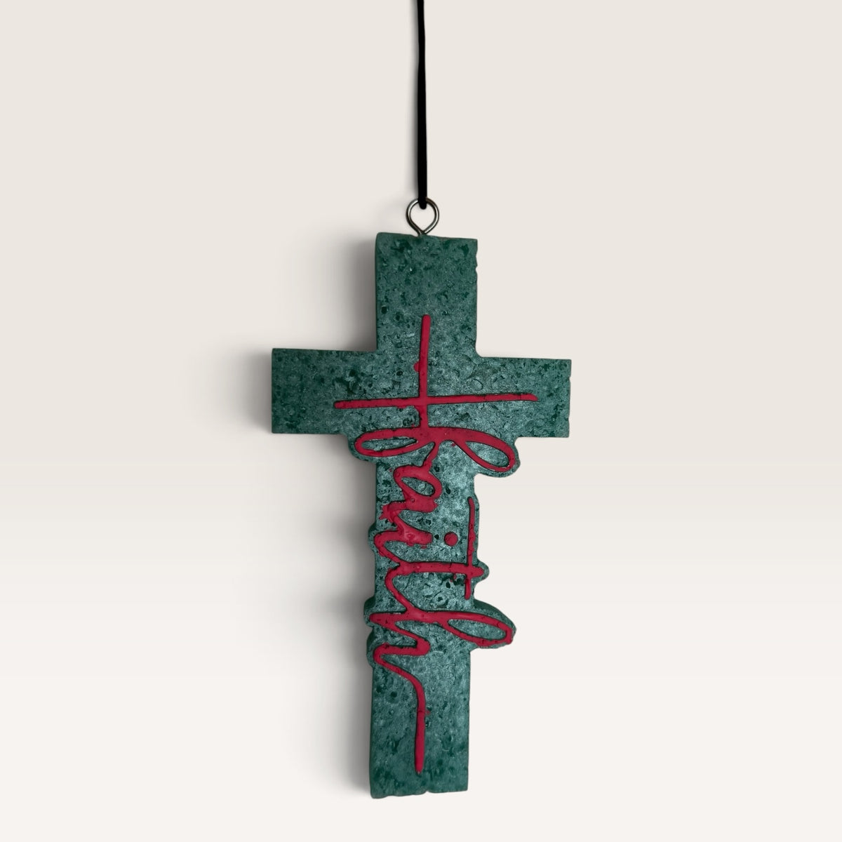 Sadie's handmade Faith cross car freshie in turquoise with pink lettering.